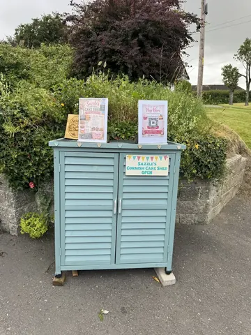 A blue container with a sign on it.