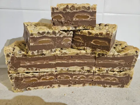 A stack of brownies on a table.