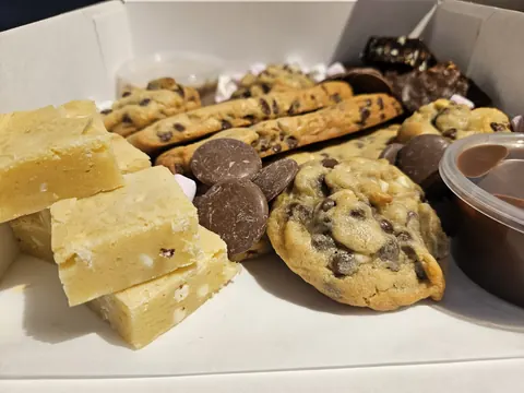 A box of assorted cookies and cakes.