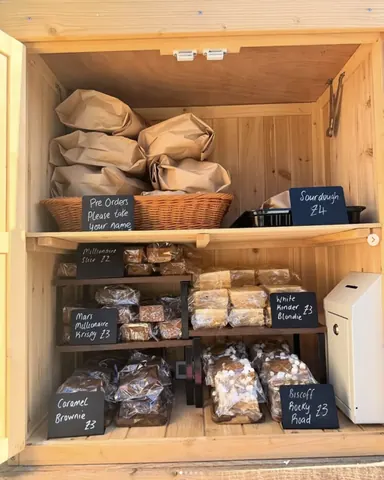 A wooden shelf with a sign that says "please choose your order".