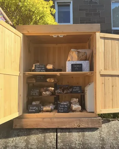 A wooden box with a sign that says "The Daily Bread" on it.
