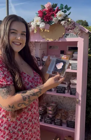 A woman holding a box with a heart on it.