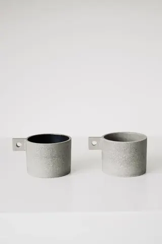 Two grey cups on a white background.