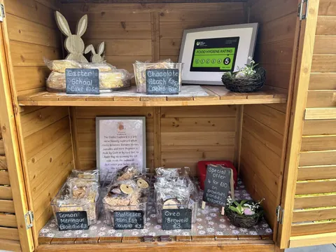 A wooden box with a sign that says "Bunny's Bakery" on it.