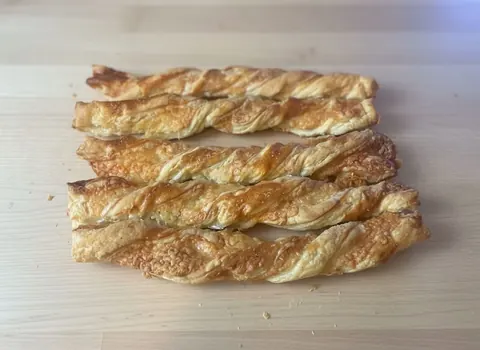 A wooden table with a piece of food on it.