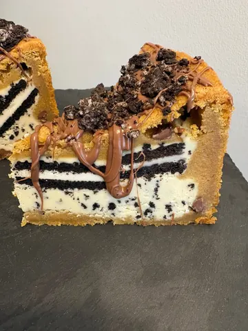 A slice of cake with chocolate and vanilla frosting.