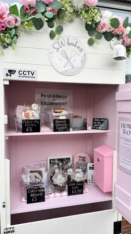 A pink cabinet with a clock on it.
