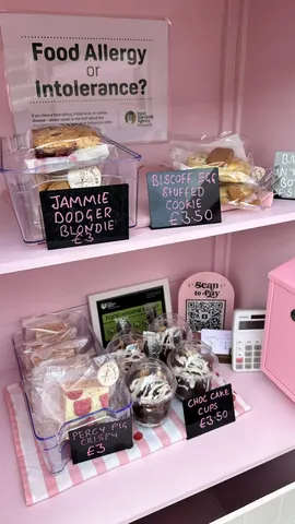 A display of various baked goods, including cakes and cookies, is visible.