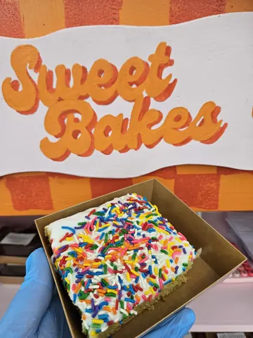 A box of a cake with sprinkles on it.