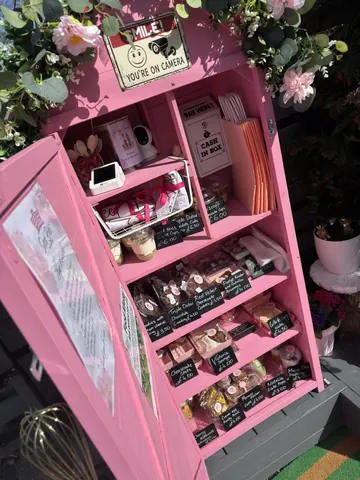 A pink cabinet with a sign that says "You are on camera".