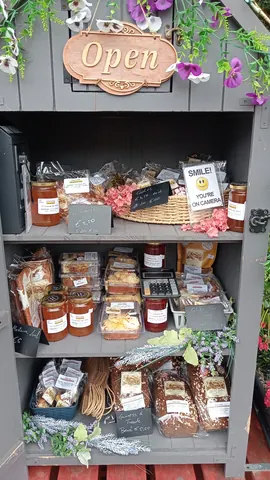 A jar of jam is on a shelf.