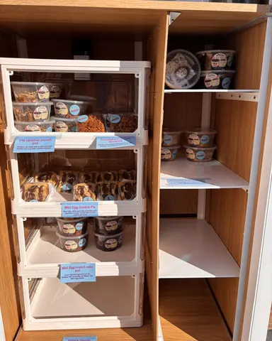 A white shelf with food items on it.