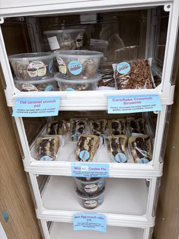 A display case with a variety of food items in it.