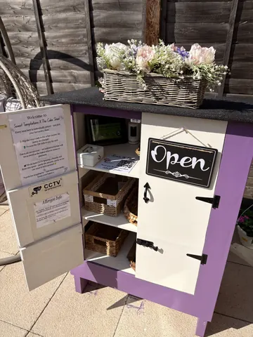 A small white box with a sign that says "open" on it.