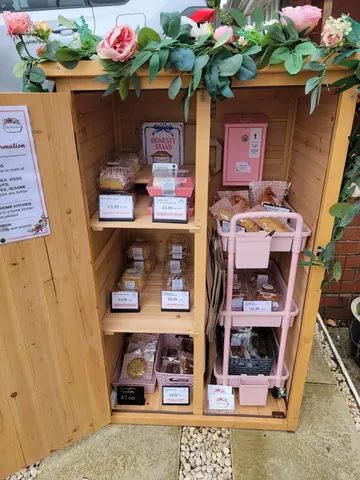 A wooden box with a pink interior and a sign on the side.