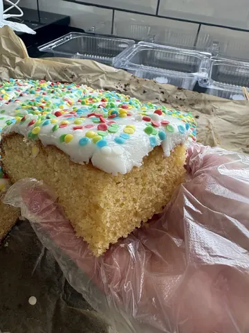 A person is holding a piece of cake.