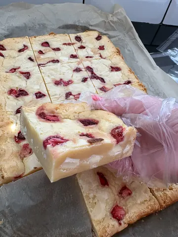 A person is cutting a cake with a knife.