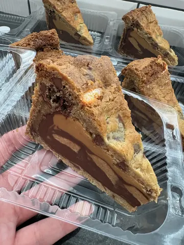 A slice of chocolate cake in a plastic container.