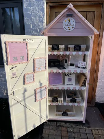 A small pink building with a sign that says "local" on it.