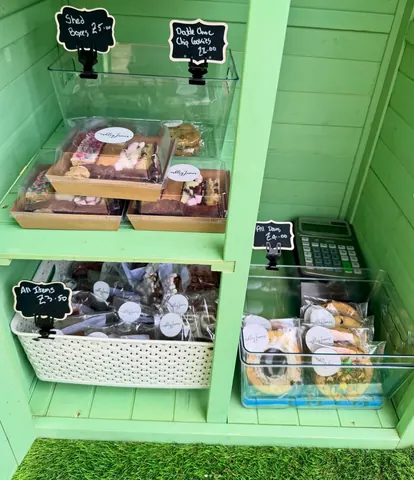 A green shelf with a calculator on it.