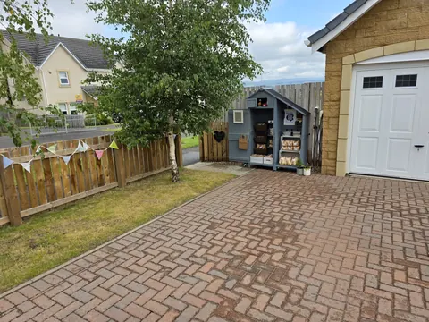 A small shed with a sign on it.