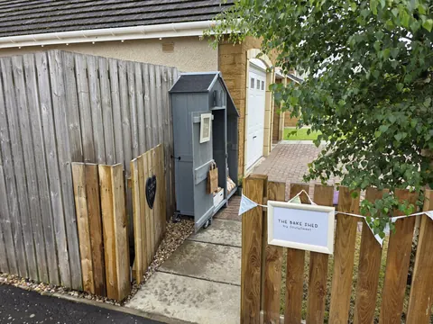 A small shed with a sign on the door.