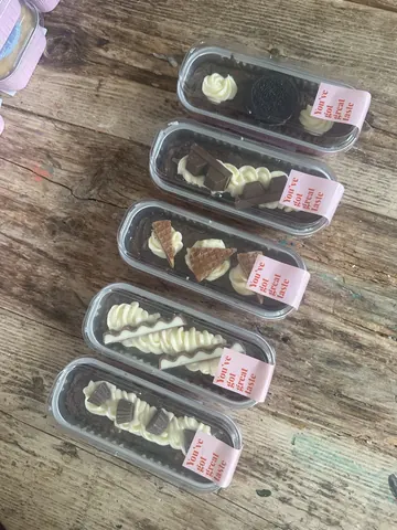 A table with a bunch of chocolate candies on it.