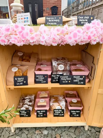 A wooden shelf with a variety of food items on it.