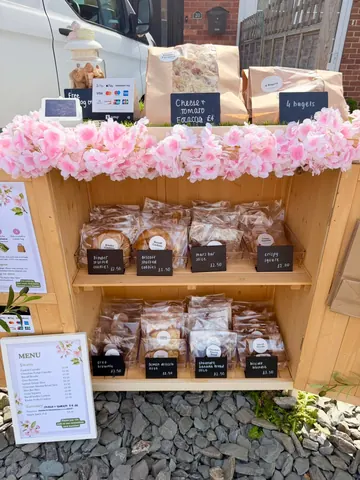 A wooden display case with a variety of food items in it.