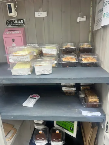 A pink box with a sign that says "Pay Here" on it.