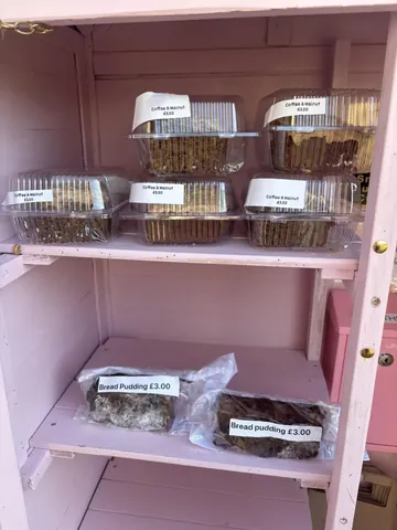 A pink shelf with a sign that says "Coffee Muffins" on it.