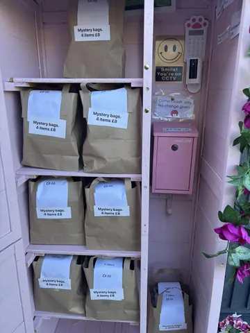 A pink box with a sign that says "mystery bags" on it.