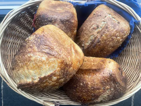 A basket of bread is sitting on a table.