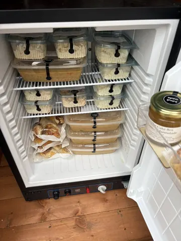 A refrigerator with a bunch of food in it.