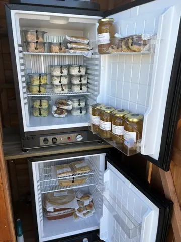 A refrigerator with a lot of food in it.