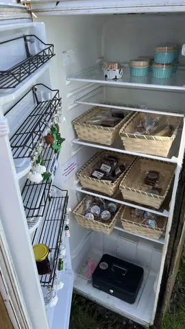 A refrigerator with a basket of food inside.
