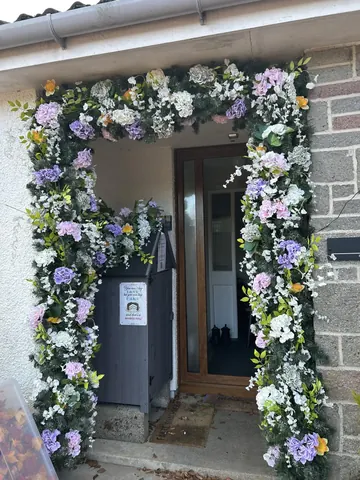 A doorway with a flower garland on it.