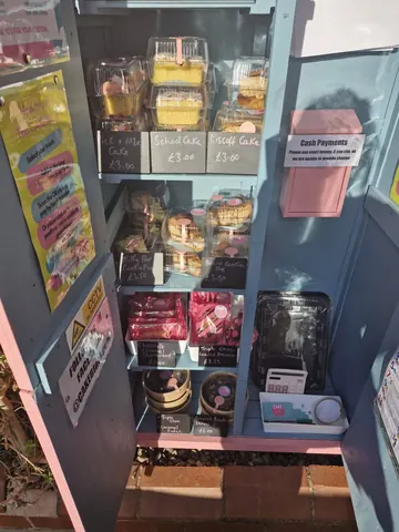 A pink and blue cabinet with a sign that says "cash payments accepted".
