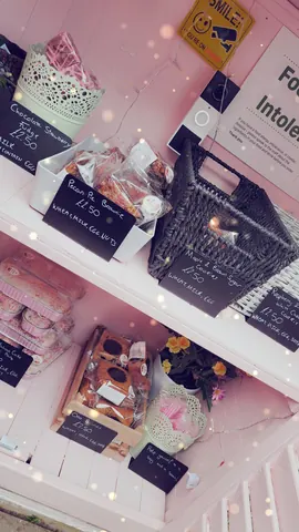 A pink shelf with a basket of food on it.