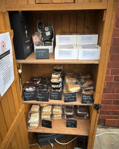 A wooden shelf with a sign that says "Cakes" on it.