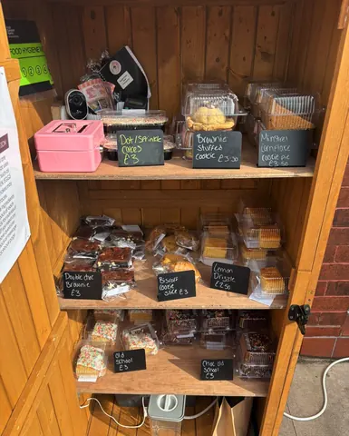 A wooden cabinet with a sign that says "Baked goods".