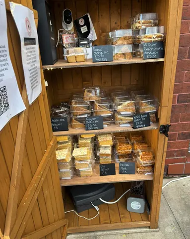 A wooden cabinet with a black box on the bottom.