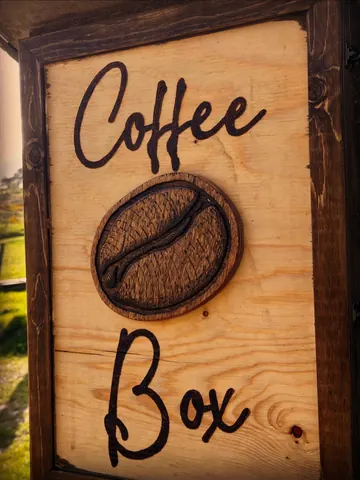A wooden sign with the word coffee written on it.