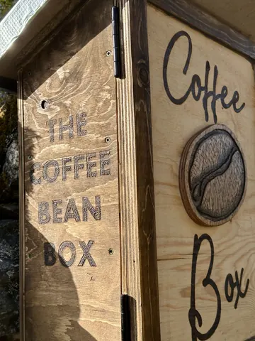 A wooden box with a coffee bean logo on it.