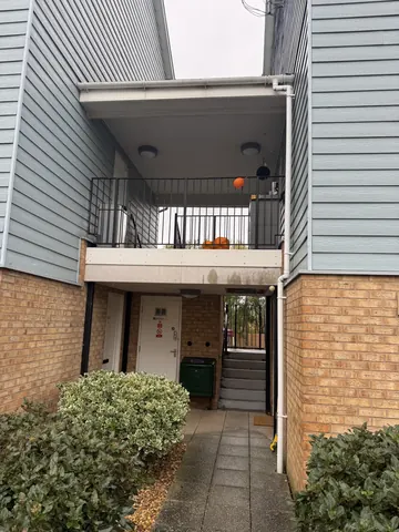 A building with a balcony and a pumpkin on it.