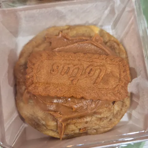 A cookie with chocolate frosting and a sugar cookie.