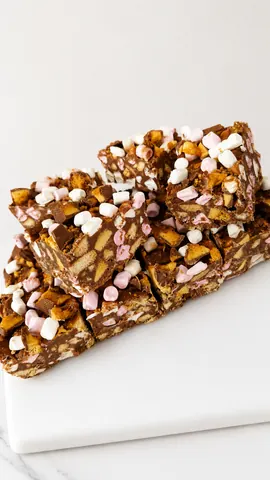 A piece of candy with marshmallows on top.