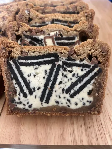 A piece of cake with chocolate and white frosting.