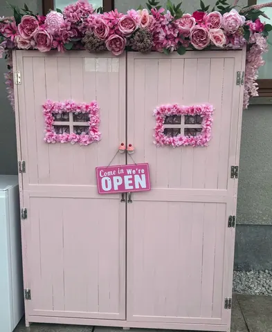 A pink door with a sign that says "open" on it.