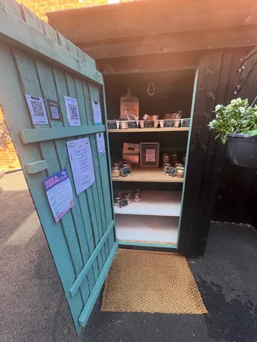 A blue door with a white shelf inside.
